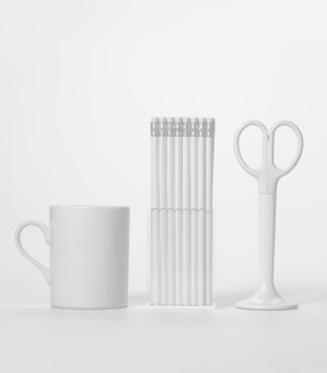 Image shows a mug, pencils and scissors. The image is used to depict Training Central’s brand identity which defines the style of our learning and development materials.